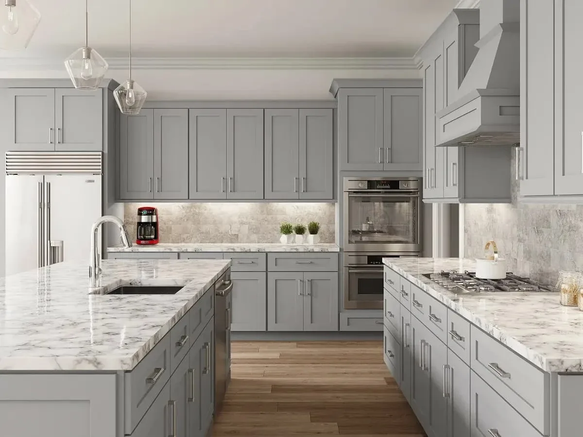 Modern gray kitchen remodel with a large marble island and stainless appliances